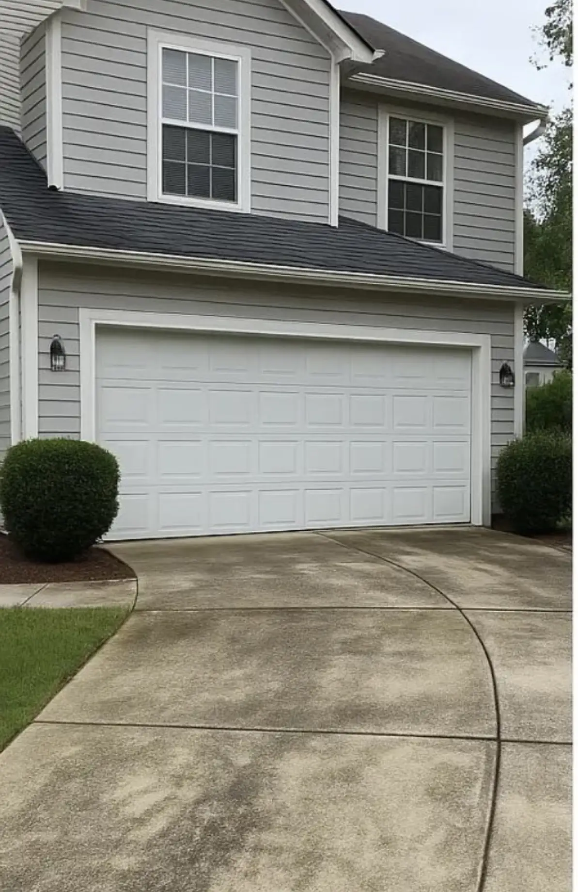 Driveway before cleaning, gray and stained