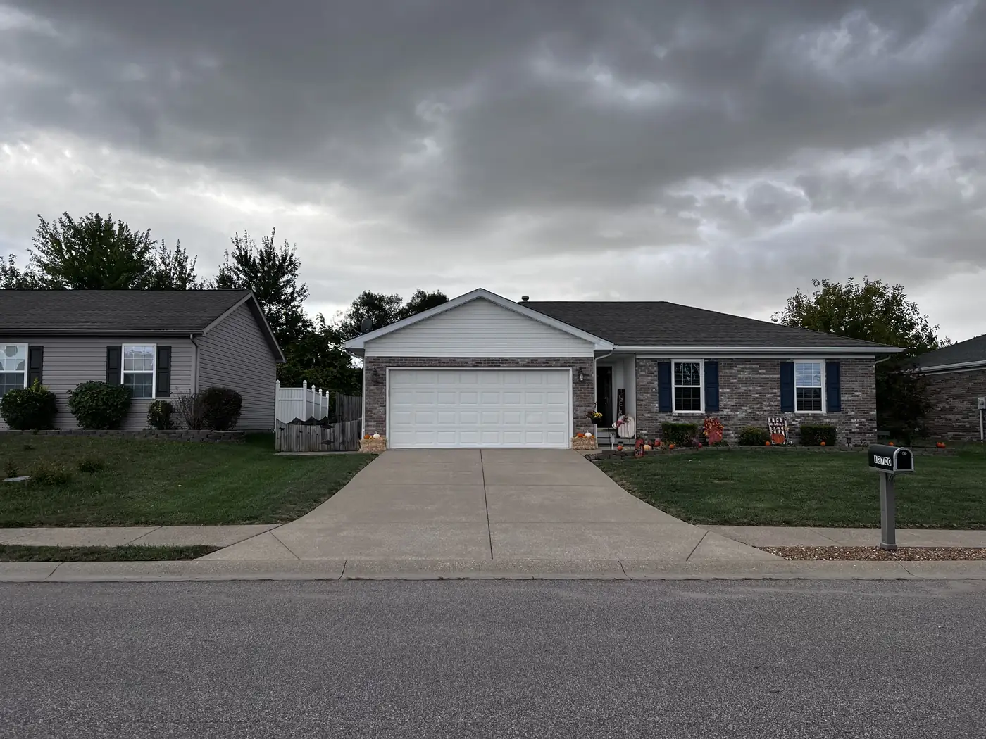 Freshly cleaned driveway running from the street to a ranch home