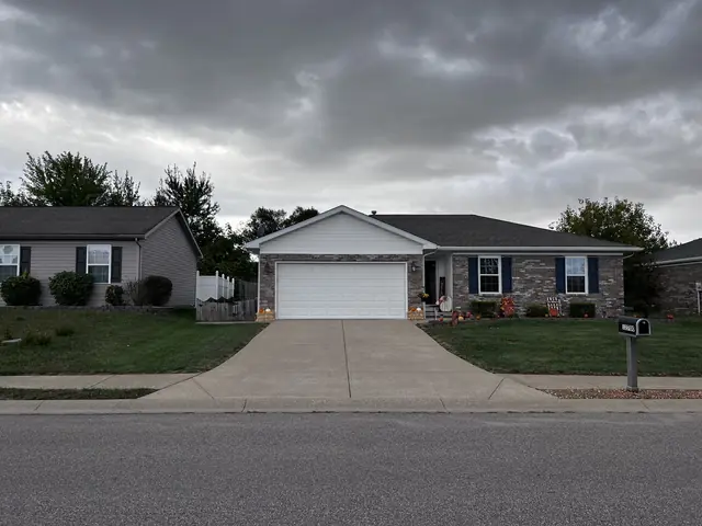 Freshly cleaned driveway running from the street to a ranch home