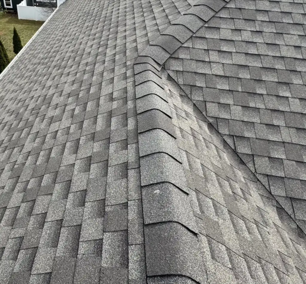 Close view of an asphalt shingle roof ridge