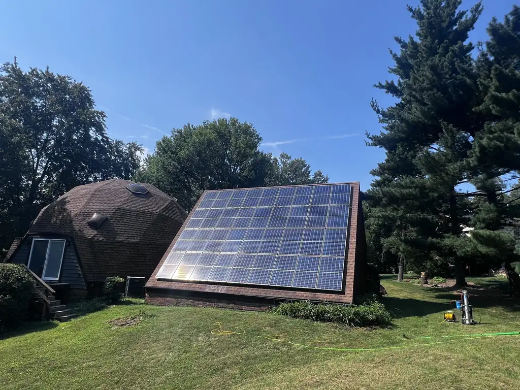 Solar array on an A-frame roof after cleaning, glass shining in the sun