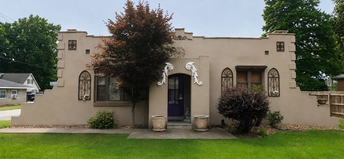 Stucco home with arched windows after a soft wash
